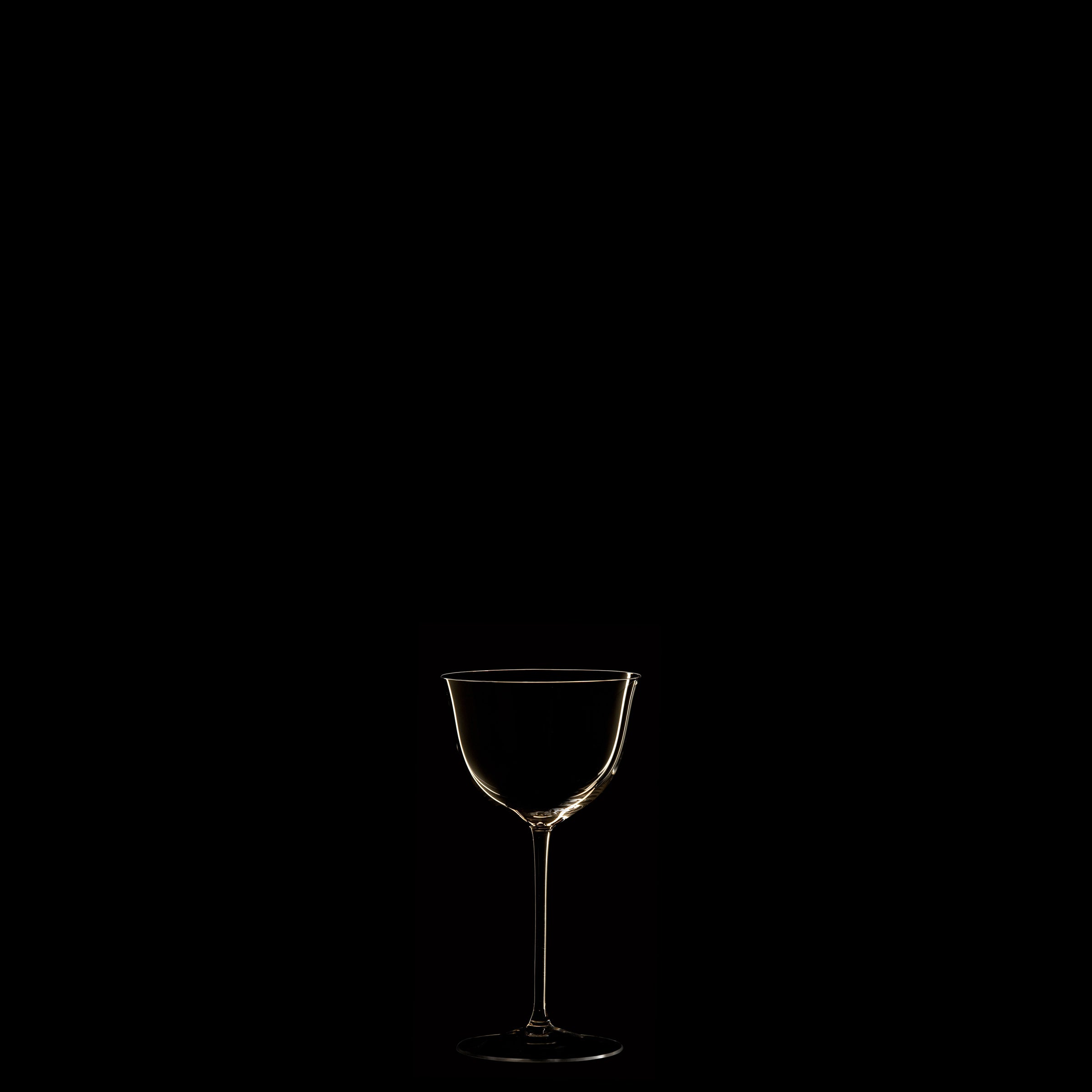 A single transparent wine glass from the Drinking Set No. 238 - Patrician by Lobmeyr, crafted from mouth-blown crystal, stands in the center on a dark black background, subtly lit to reveal its silhouette.