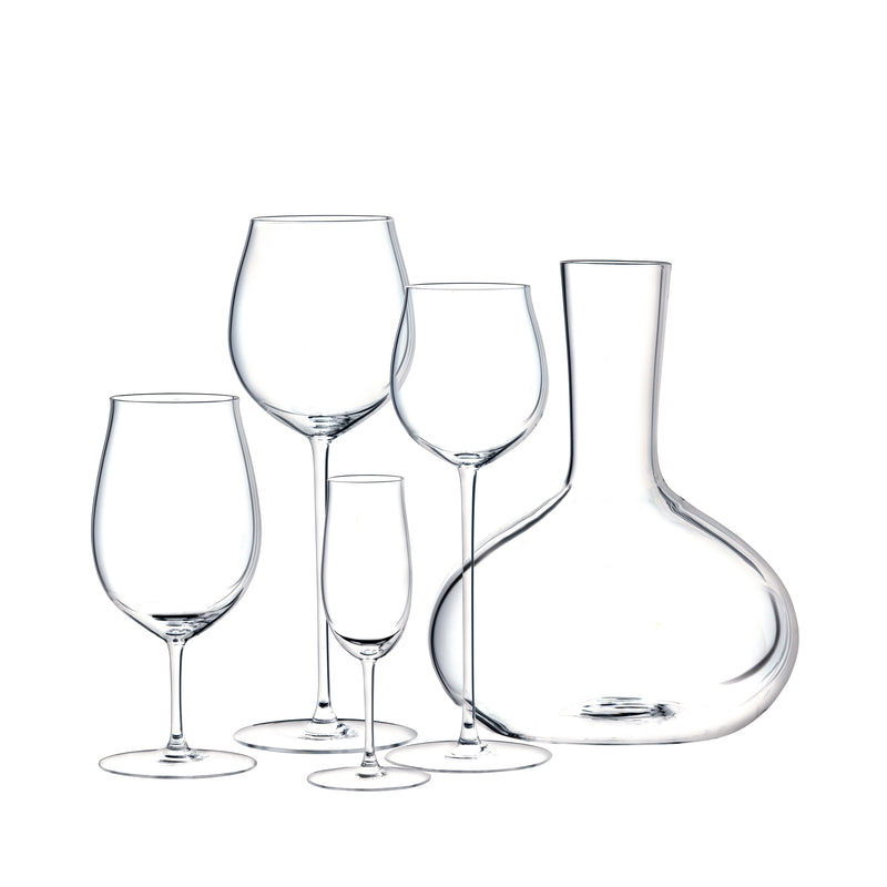 The Lobmeyr Drinking Set No. 276 - Ballerina features mouth-blown, lead-free crystal glassware including three exquisite wine glasses, one champagne flute, and an elegantly curvy wine decanter, all beautifully arranged against a white background.