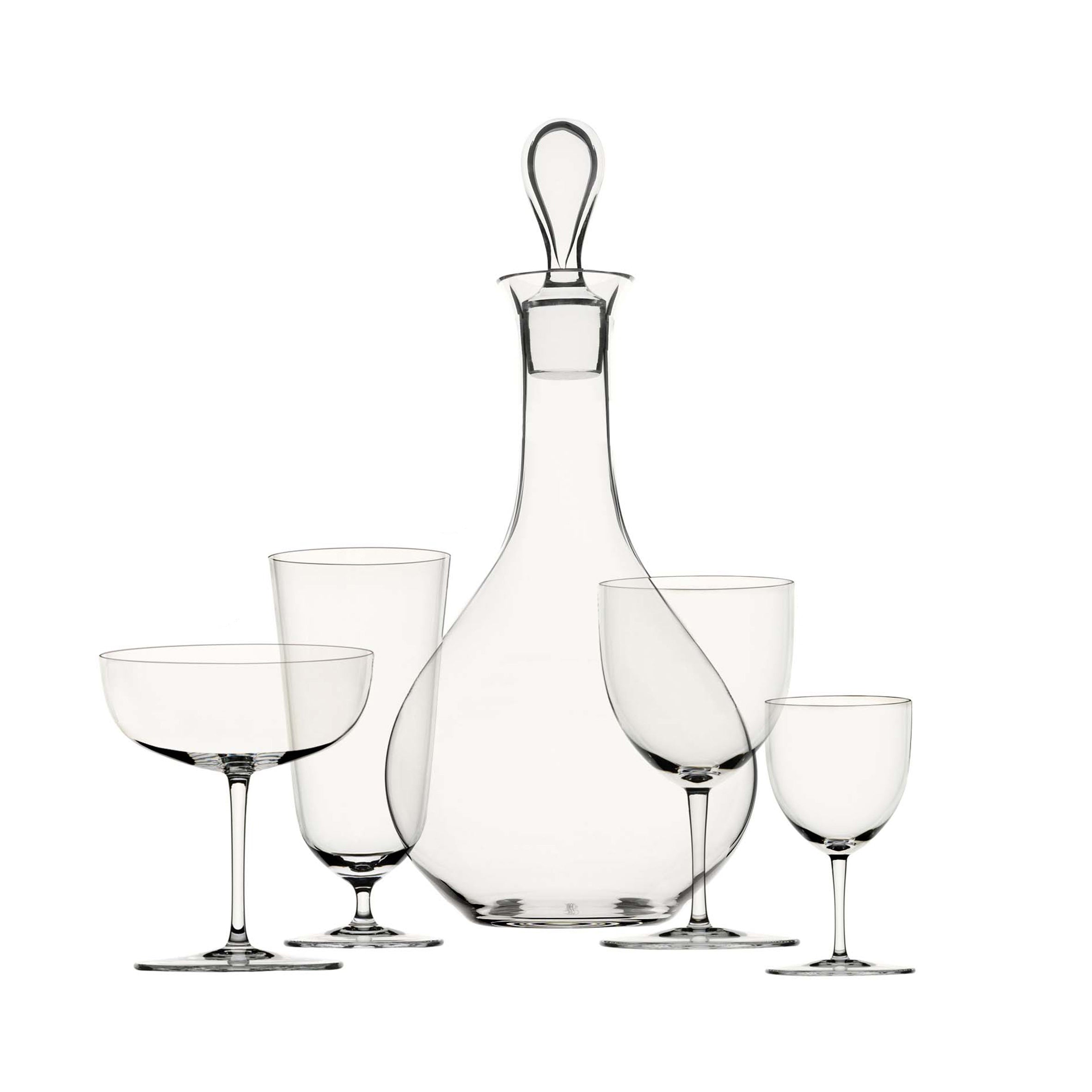 The Lobmeyr Drinking Set No. 4 includes a tall decanter with a stopper and four clear glasses of varying sizes, elegantly arranged against a white background.