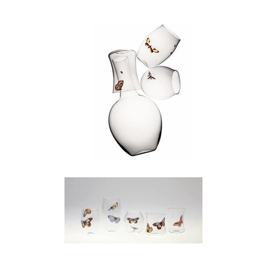 The image features Lobmeyrs Drinking Set No. 279 - Balloon, a decanter and tumblers crafted from mouth-blown lead-free crystal with delicate butterfly designs, alongside Ted Muehling glasses each uniquely patterned with butterflies, all arranged on a white background.