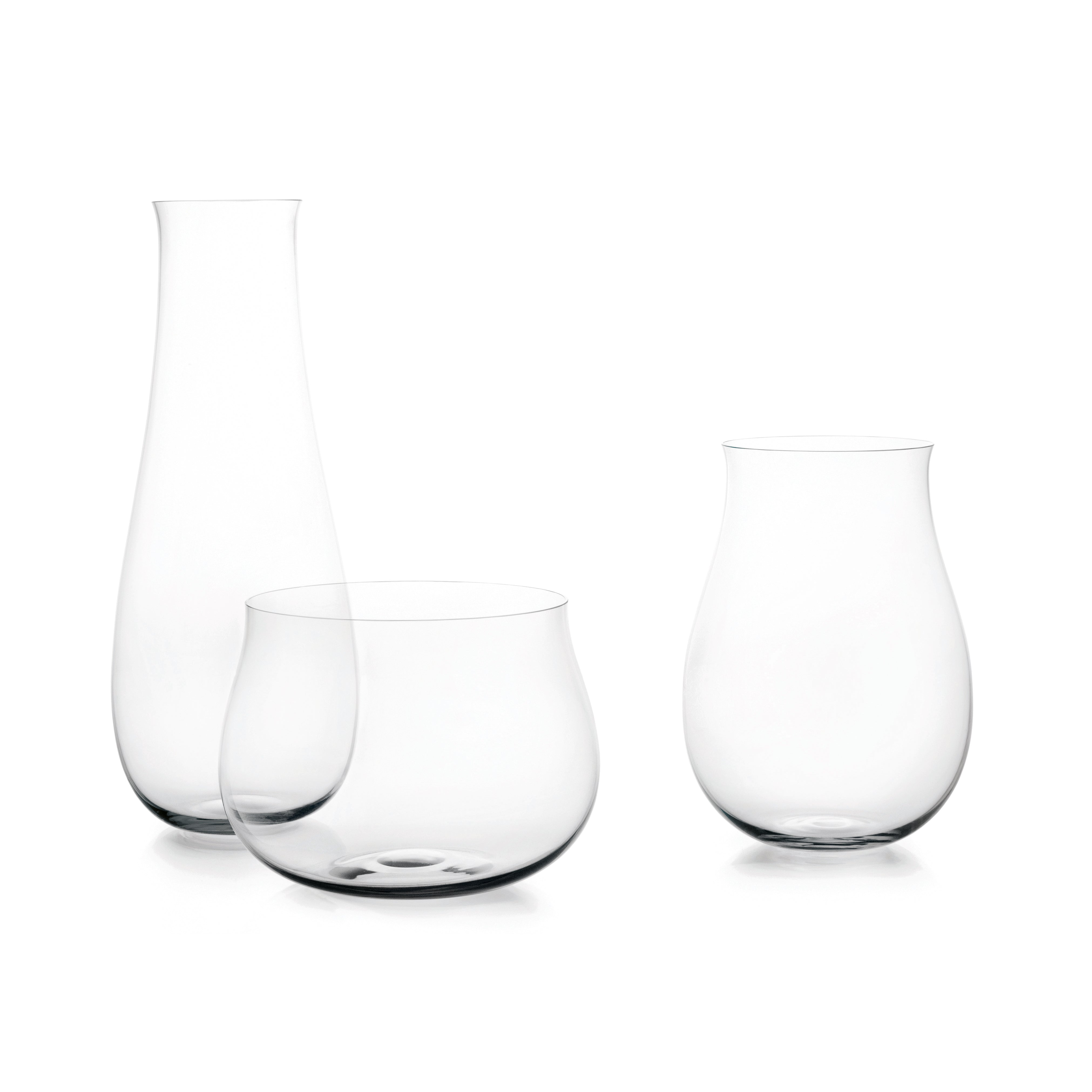 The BV69 Drop Vases by Lobmeyr are three sleek, minimalist glass vases of different shapes and sizes, set against a white background. Mouth-blown design highlights their modern elegance, making them ideal for creative flower arrangements.