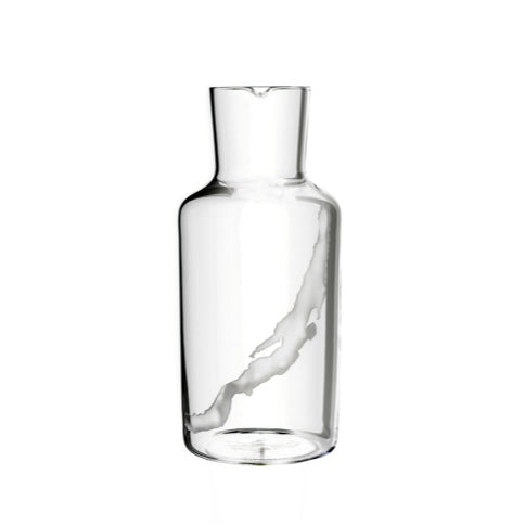 The Lobmeyr Fortune Series bottle is mouth-blown crystal with a cylindrical shape and narrow neck, featuring a diagonal white streak. Perfect as a water carafe, it stands gracefully against the plain white background.