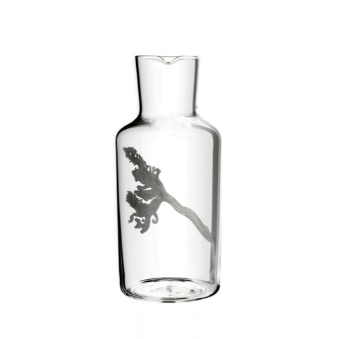 The Fortune Series by Lobmeyr is a mouth-blown crystal water carafe with an elegant shape featuring a broccoli-shaped engraved design. Its wide base tapers into the neck with a small pouring spout, adding playfulness to its simplicity.