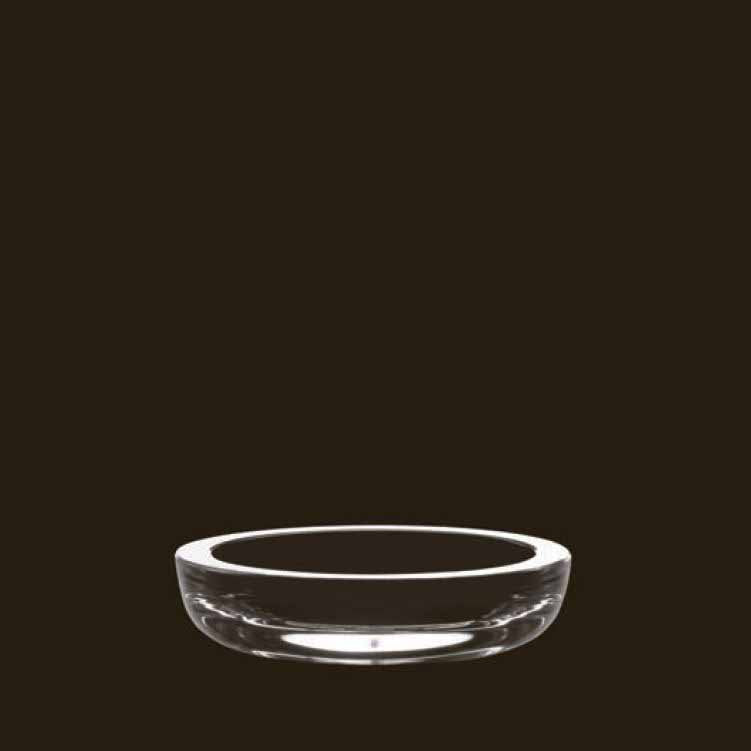 The Lobmeyr Little Massive Dish, a shallow glass bowl crafted from lead-free crystal, is displayed against a plain black background, showcasing its simple yet elegant design reminiscent of classic Lobmeyr pieces.