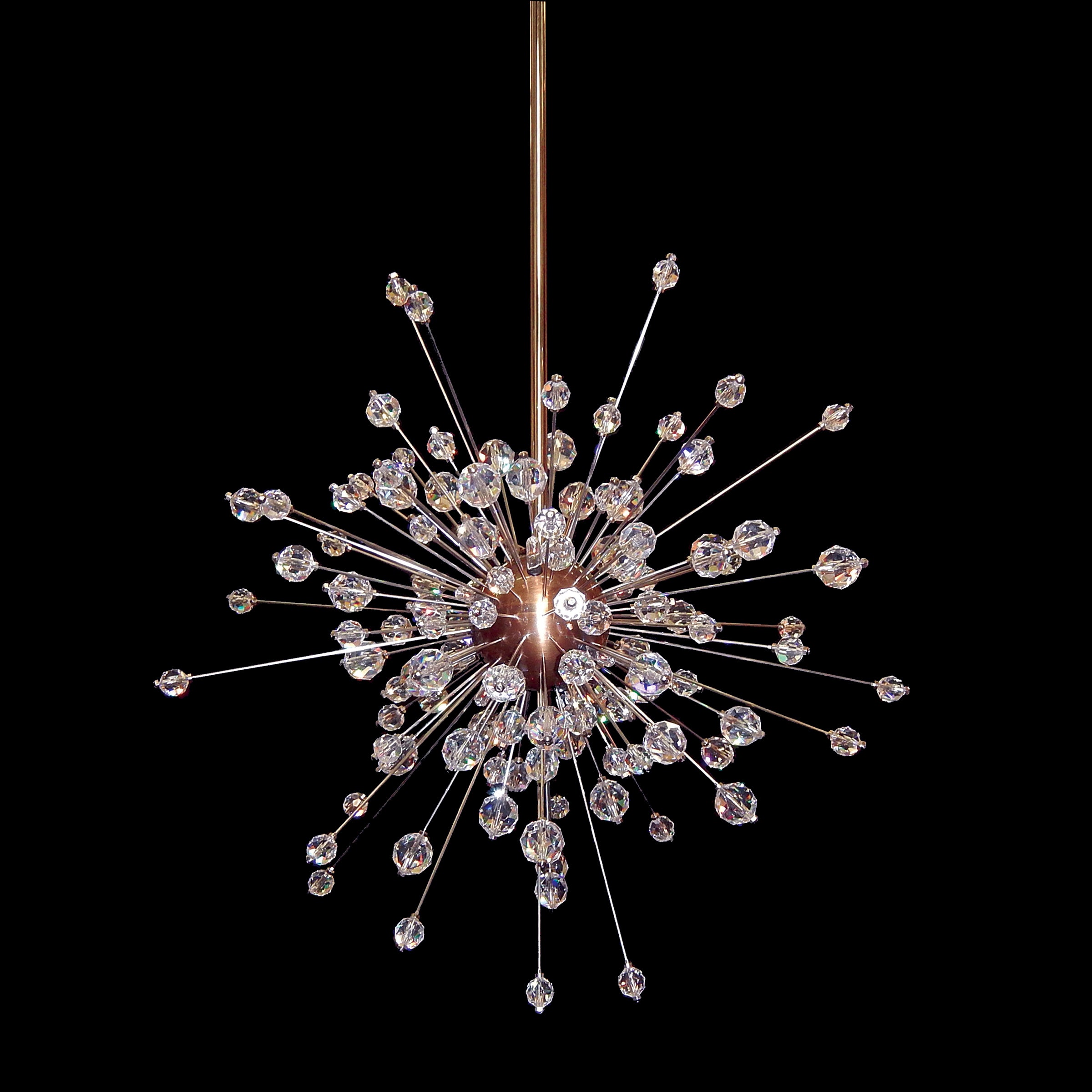 The Mini Sputnik from Lobmeyrs Met Series hangs against a black background, its numerous spokes ending in dazzling Swarovski crystal orbs resembling an exploding firework.