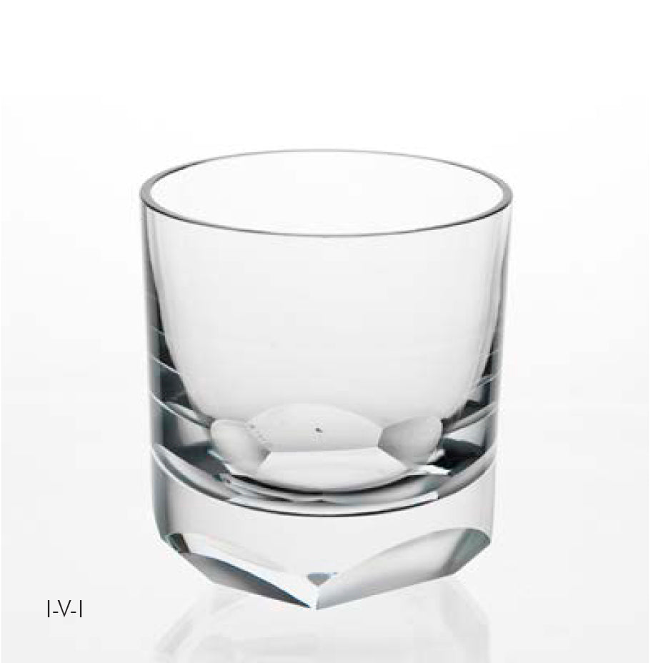 On a plain white background, a clear, empty glass with a thick base and slightly tapered design captures the elegance of the Lobmeyr Neo Cut I Collection, echoing the contemporary ornament style reminiscent of Vienna Design Week.