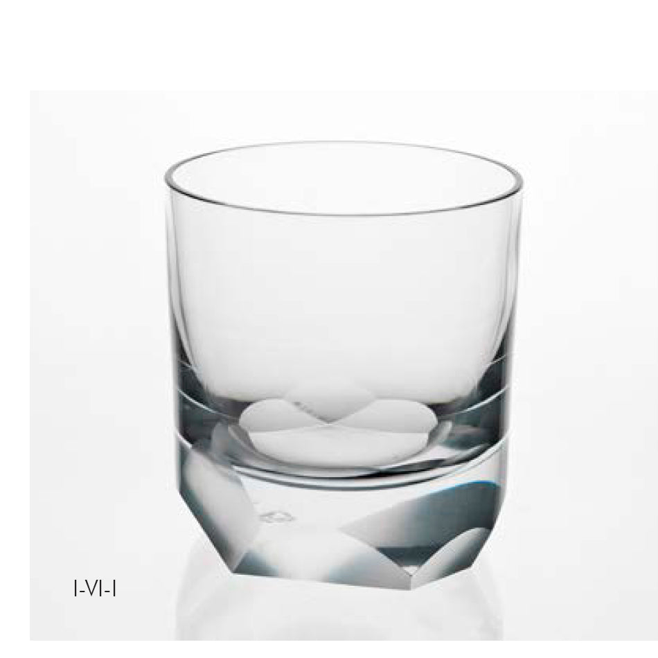 On a white background, the Neo Cut I Collection drinking glass by Lobmeyr resembles a whiskey tumbler with its wide opening and subtly narrowing base, highlighted by geometric detailing that adds contemporary ornamentation.