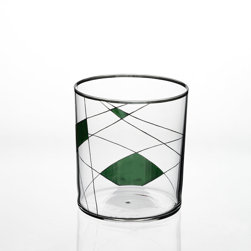 The Neo Light X by Lobmeyr is a transparent cylindrical glass with thin black lines and green geometric shapes, featuring intersecting lines that form triangular and diamond patterns, highlighting Martino Gampers innovative style.