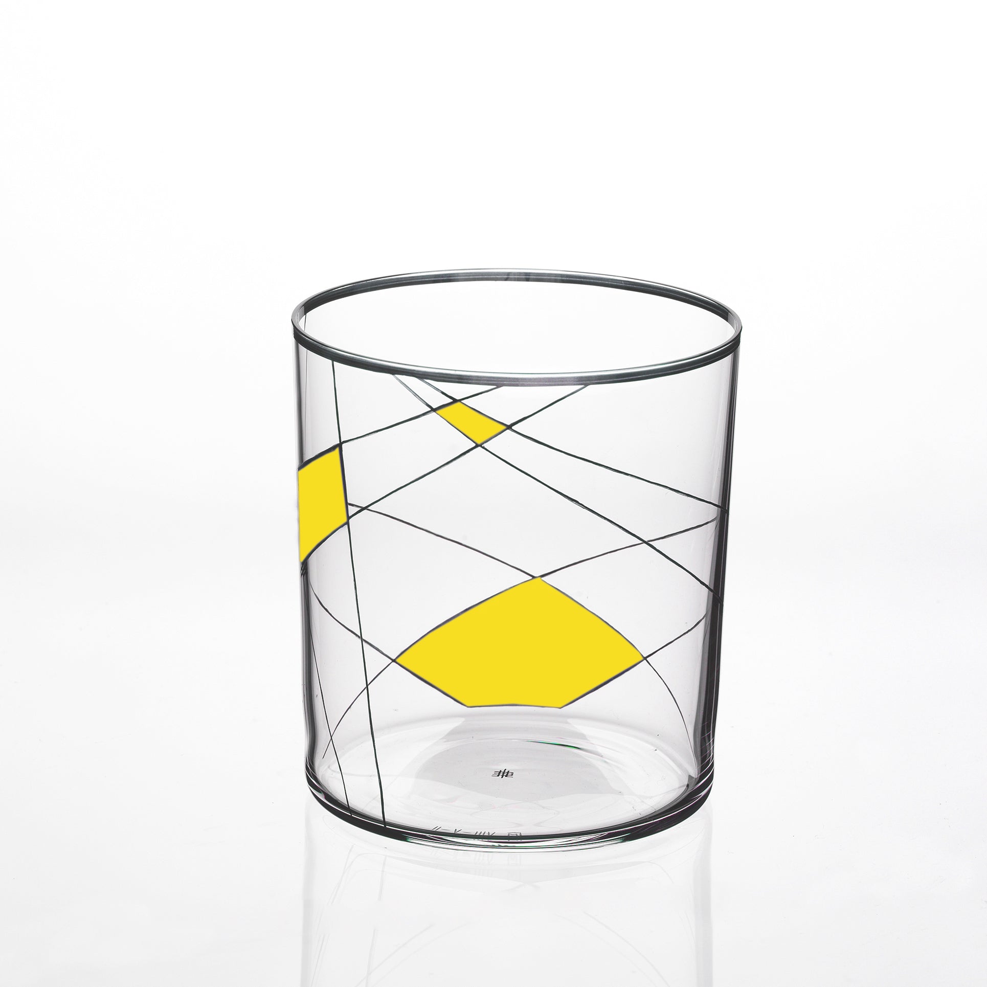 The Neo Light X from Lobmeyr is a clear glass tumbler showcasing a geometric design with curved black lines and bold yellow diamonds. Its plain white background highlights the modern artistic pattern, reminiscent of Martino Gampers style.