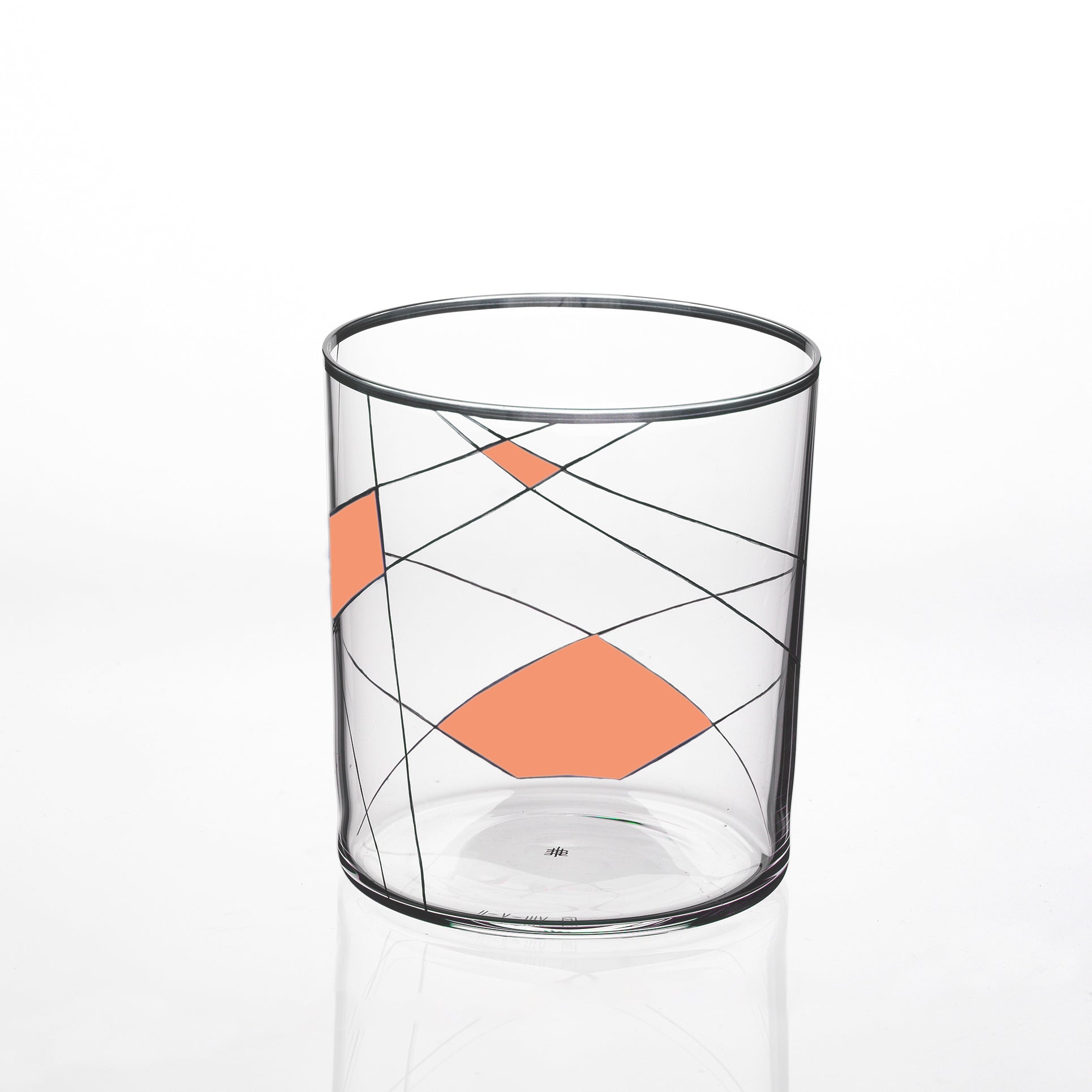 The Neo Light X tumbler by Lobmeyr features a modern design with intersecting black lines and orange geometric shapes on a plain white backdrop, giving it the look of a contemporary ornament.