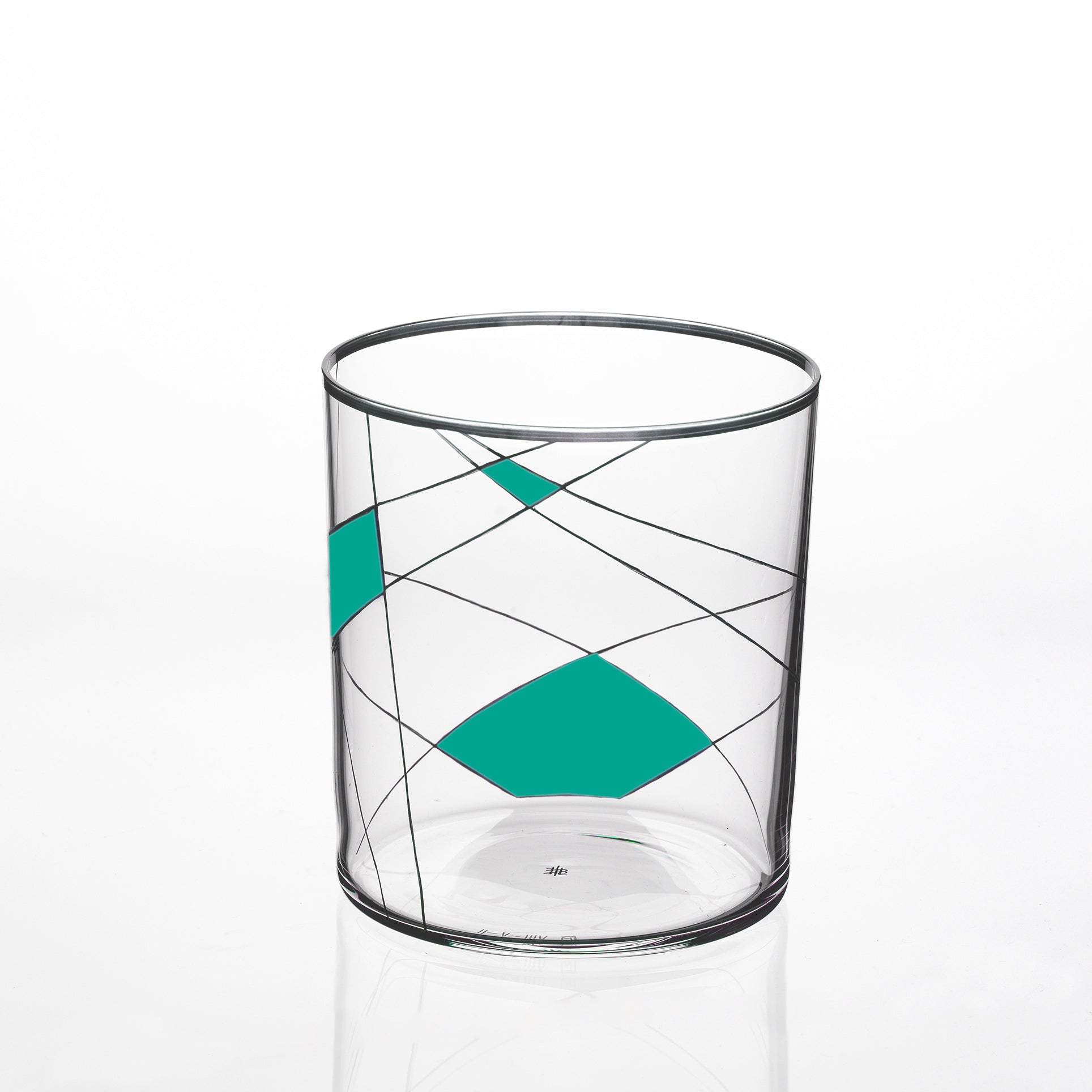 The Neo Light X glass tumbler by Lobmeyr, in collaboration with Martino Gamper, showcases a modern design with intersecting black lines and teal geometric shapes on a white background.