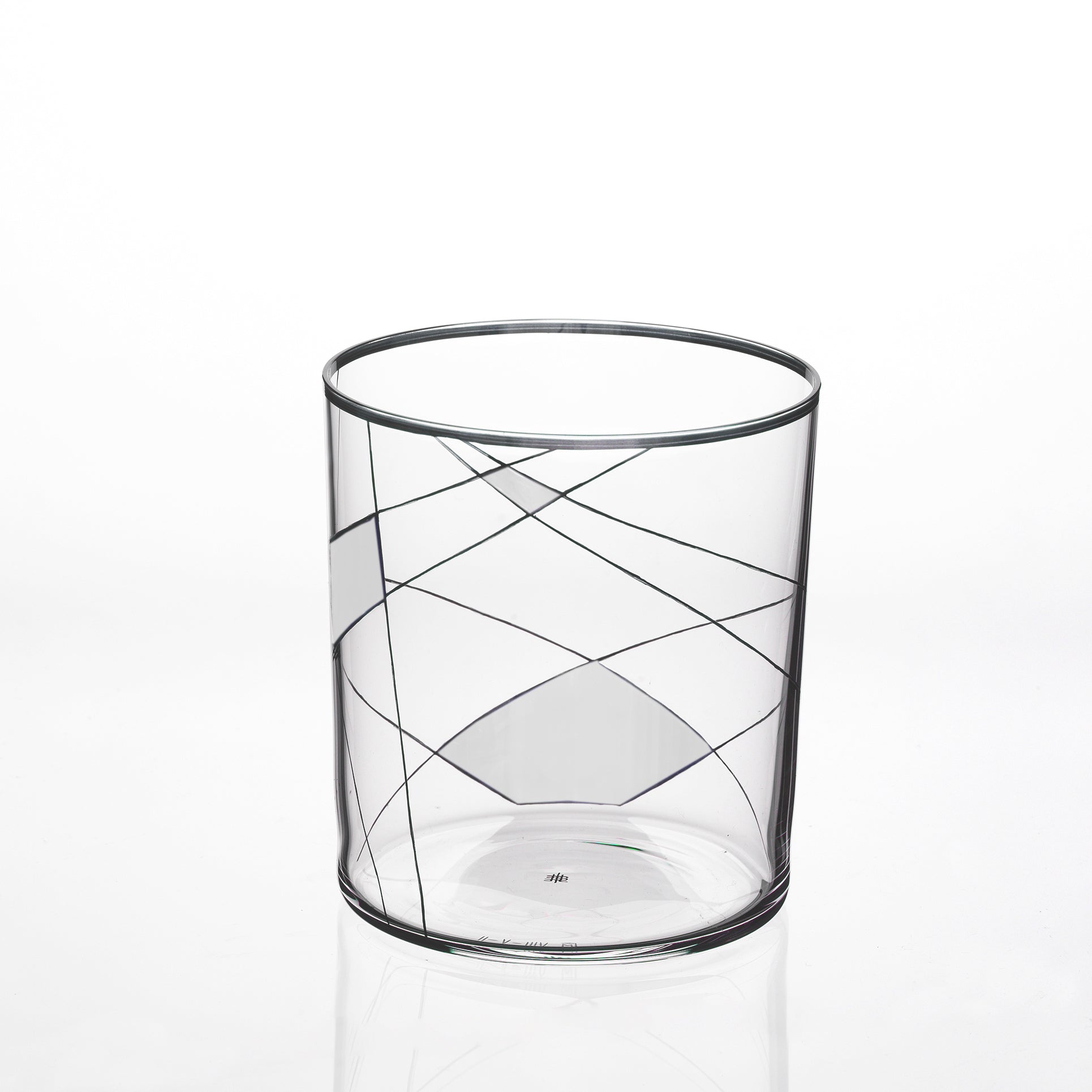 The Neo Light X by Lobmeyr is a clear glass tumbler adorned with abstract black swirling lines on a white background, showcasing Martino Gampers flair for modern ornamentation.