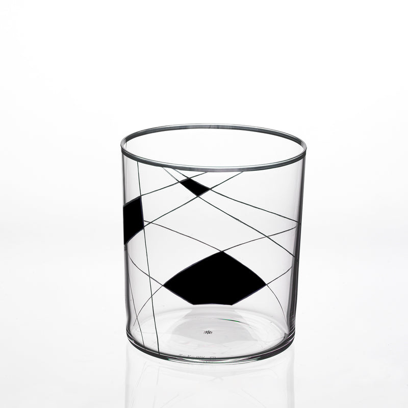 The Lobmeyr Neo Light X is a modern clear glass tumbler with black geometric shapes and intersecting lines, echoing a Martino Gamper design. Its plain white backdrop highlights the contemporary ornament pattern.