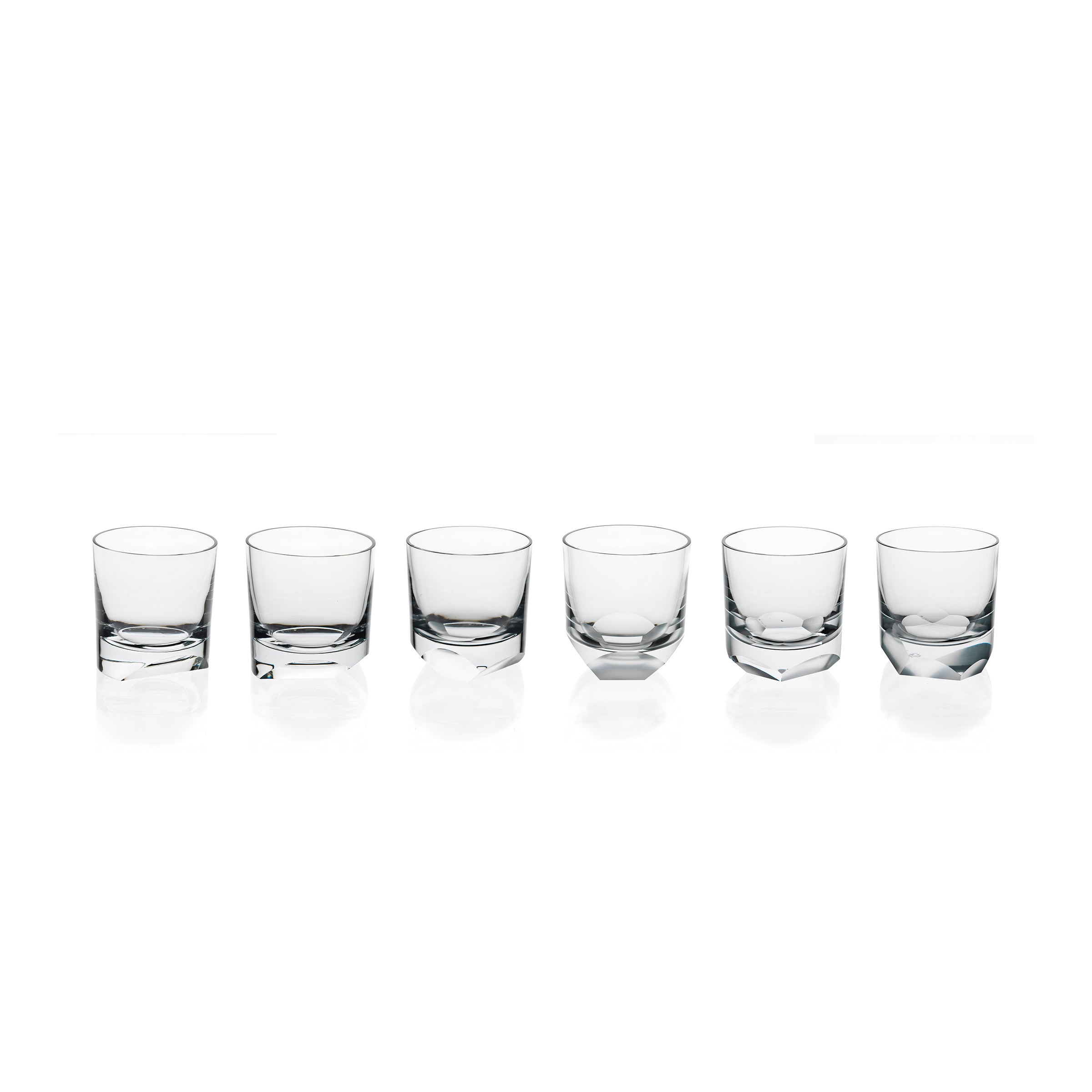 Six clear tumblers from the Neo Cut I Collection by Lobmeyr are arranged horizontally against a white background. Each sleek and rounded glass casts a subtle reflection, embodying Vienna Design Weeks modern aesthetics.