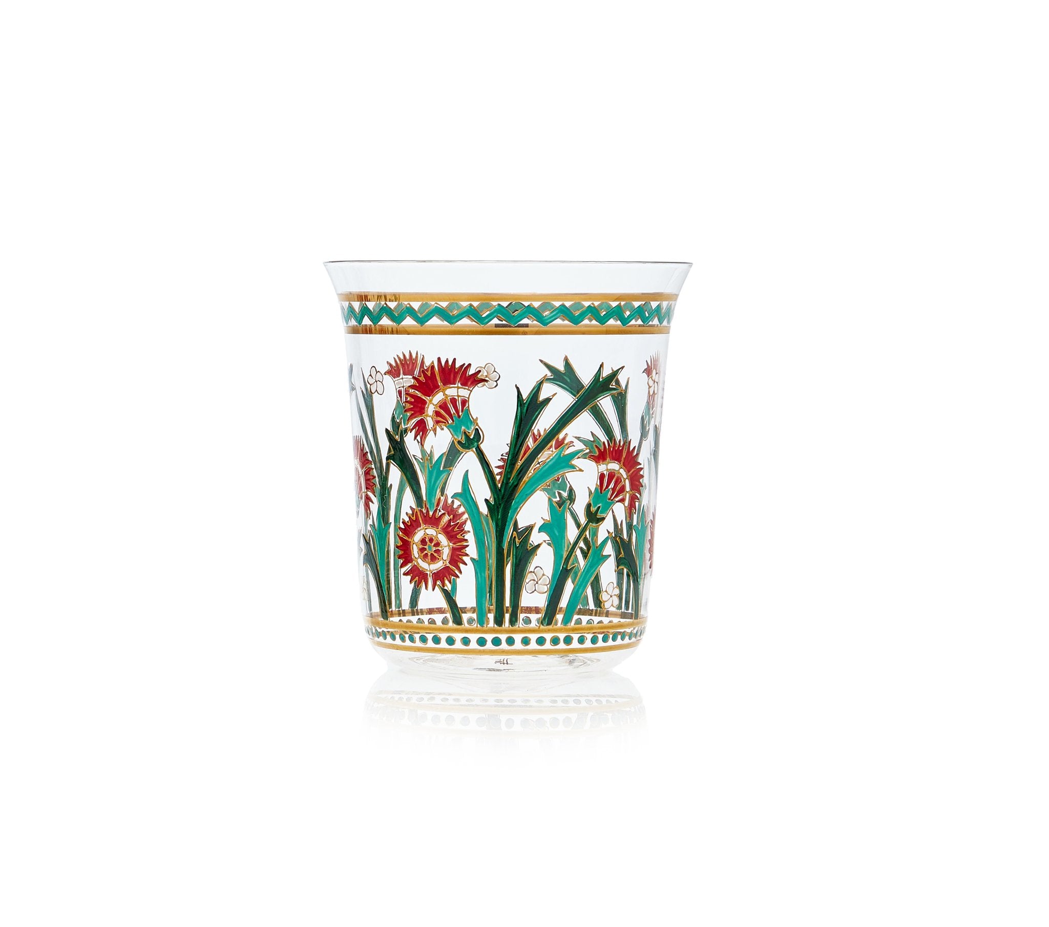 The Lobmeyr Oriental Flower Tumbler is a clear glass featuring hand-painted intricate red and green floral designs, with large flowers and grass-like leaves. A green and gold geometric pattern inspired by oriental art adorns the rim, set against a plain white background.