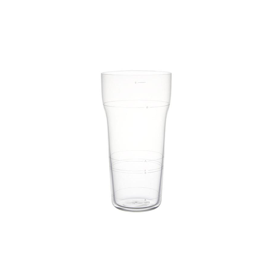 On a plain white background, Lobmeyrs Otto cup, inspired by their sleek design, sits prominently. This clear plastic cup with measurement markings has a slightly tapered base and a wider top, echoing the artistry of mouth-blown crystal.