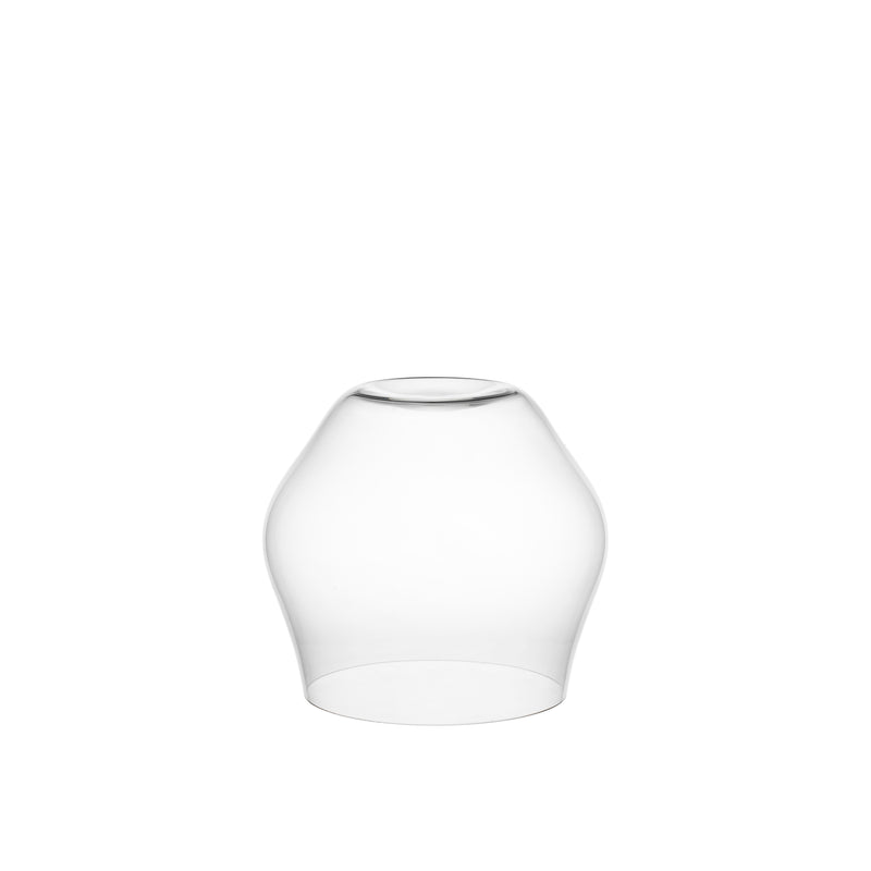 The Reigen Tumbler by Lobmeyr features a clear glass lampshade with a smooth, slightly curved conical shape open at the bottom, echoing Aldo Bakkers design, and sits elegantly against a plain white background.