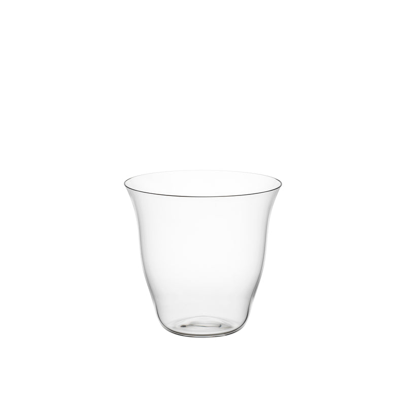 The Reigen Tumbler by Lobmeyr, a clear, transparent glass with a smooth, curving silhouette reminiscent of Aldo Bakker design, sits against a plain white background.