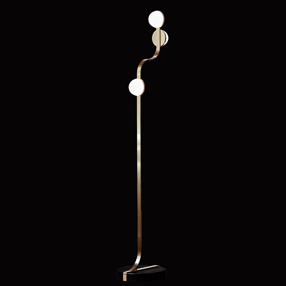 The Script Floor Lamp by Lobmeyr boasts a sleek Viennese Art Deco design with a curved gold stand and three LED-lit white globe lights. With a black oval base, it exudes timeless elegance against a solid black background.