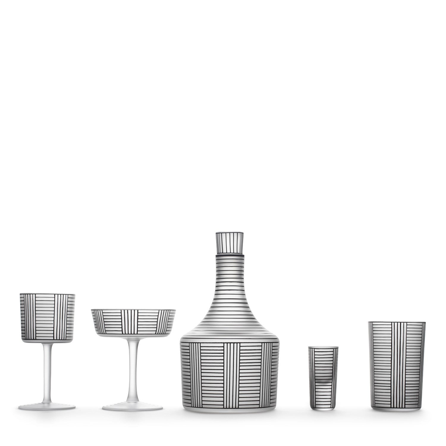 The Drinking Set Serie B by Lobmeyr showcases a carafe, two stemmed glasses, and two tumblers made of mouth-blown glass. Each white piece features a geometric black pattern with vertical and horizontal lines, reminiscent of Josef Hoffmanns style.
