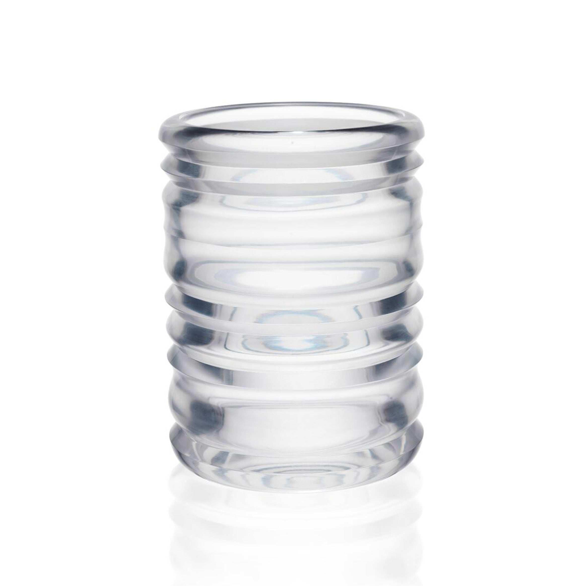 The Thom Series by Lobmeyr features a cylindrical, mouth-blown glass with ribbed, horizontal grooves. Careful design and a smooth surface reflect light subtly on a white background, showcasing Sebastian Menschhorns artistry.