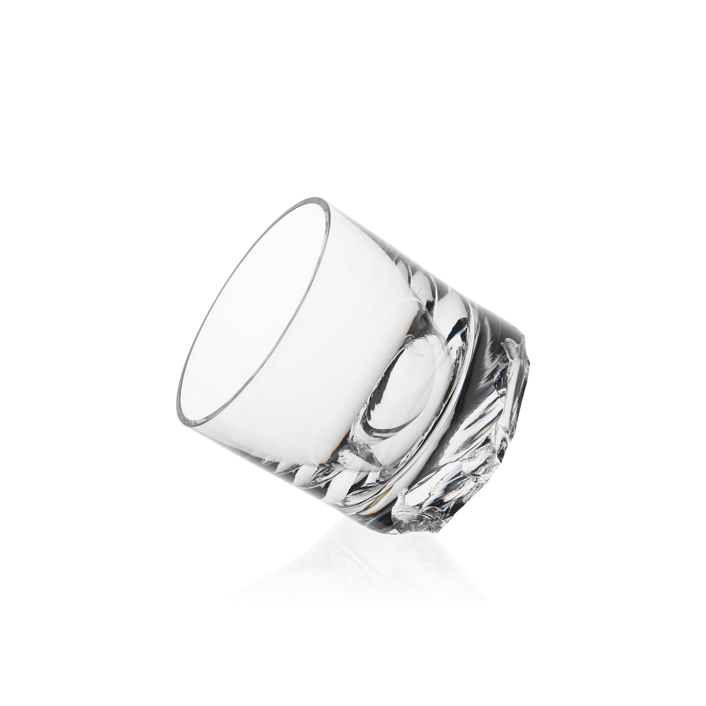 A clear, mouth-blown crystal Flint tumbler by Lobmeyr, with a smooth rim and solid textured base, designed at an angle against a white background, echoes Michael Anastassiades refined aesthetic.