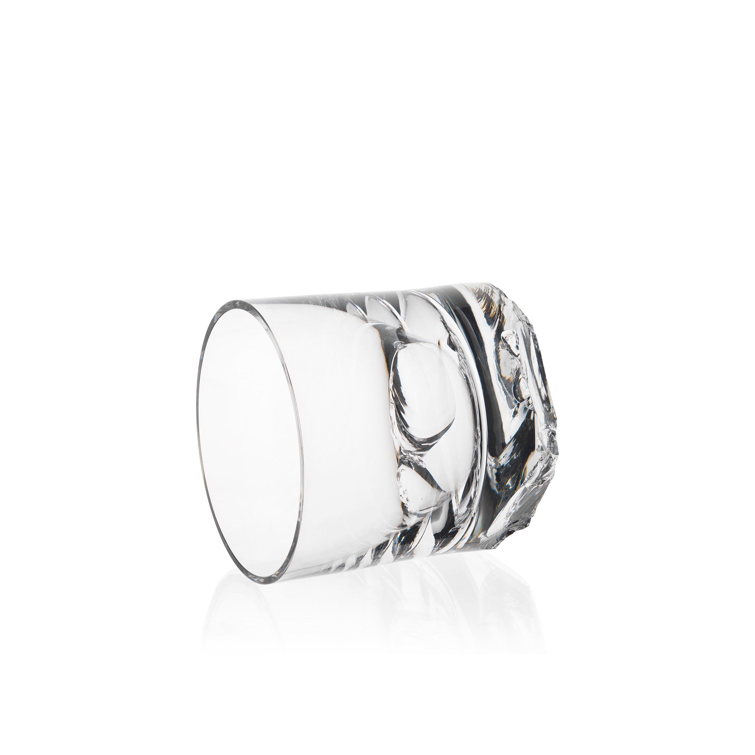 The Lobmeyr Bar Series - Flint tumbler, with its crystal-clear and intricate design, rests on its side against a plain white background, reflecting light off its smooth surface.