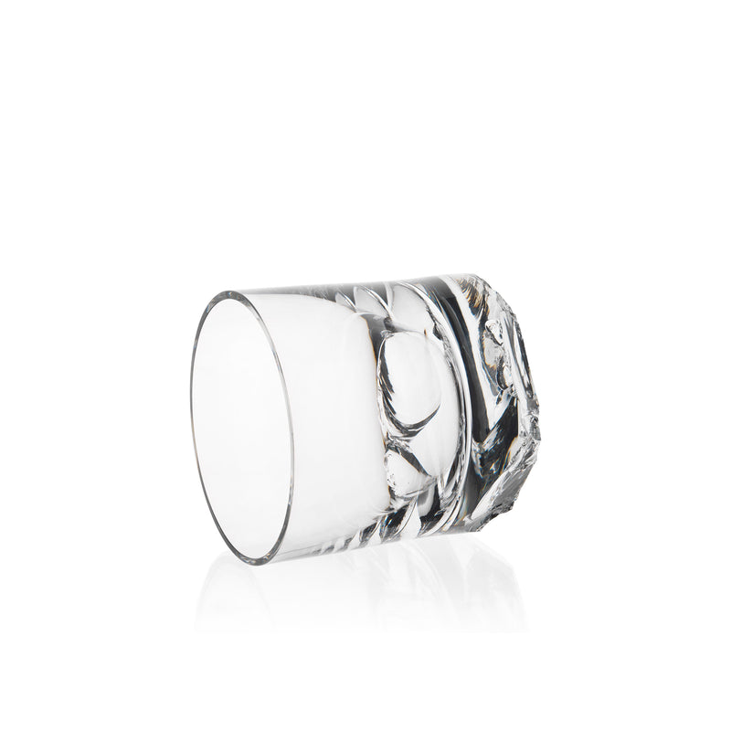 The Lobmeyr Bar Series - Flint tumbler, with its crystal-clear and intricate design, rests on its side against a plain white background, reflecting light off its smooth surface.