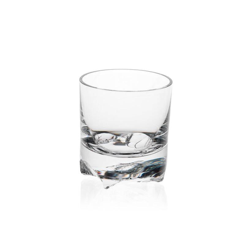 A clear Flint tumbler from the Bar Series by Lobmeyr is seen on a white background, slightly elevated. Designed by Michael Anastassiades, it has a thick base and smooth, cylindrical sides casting faint shadows below.