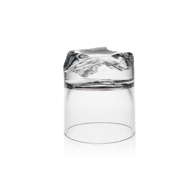 The Bar Series - Flint tumbler by Lobmeyr, designed by Michael Anastassiades, features a transparent glass design with a base resembling an inverted mountain landscape, making it a unique and captivating masterpiece.