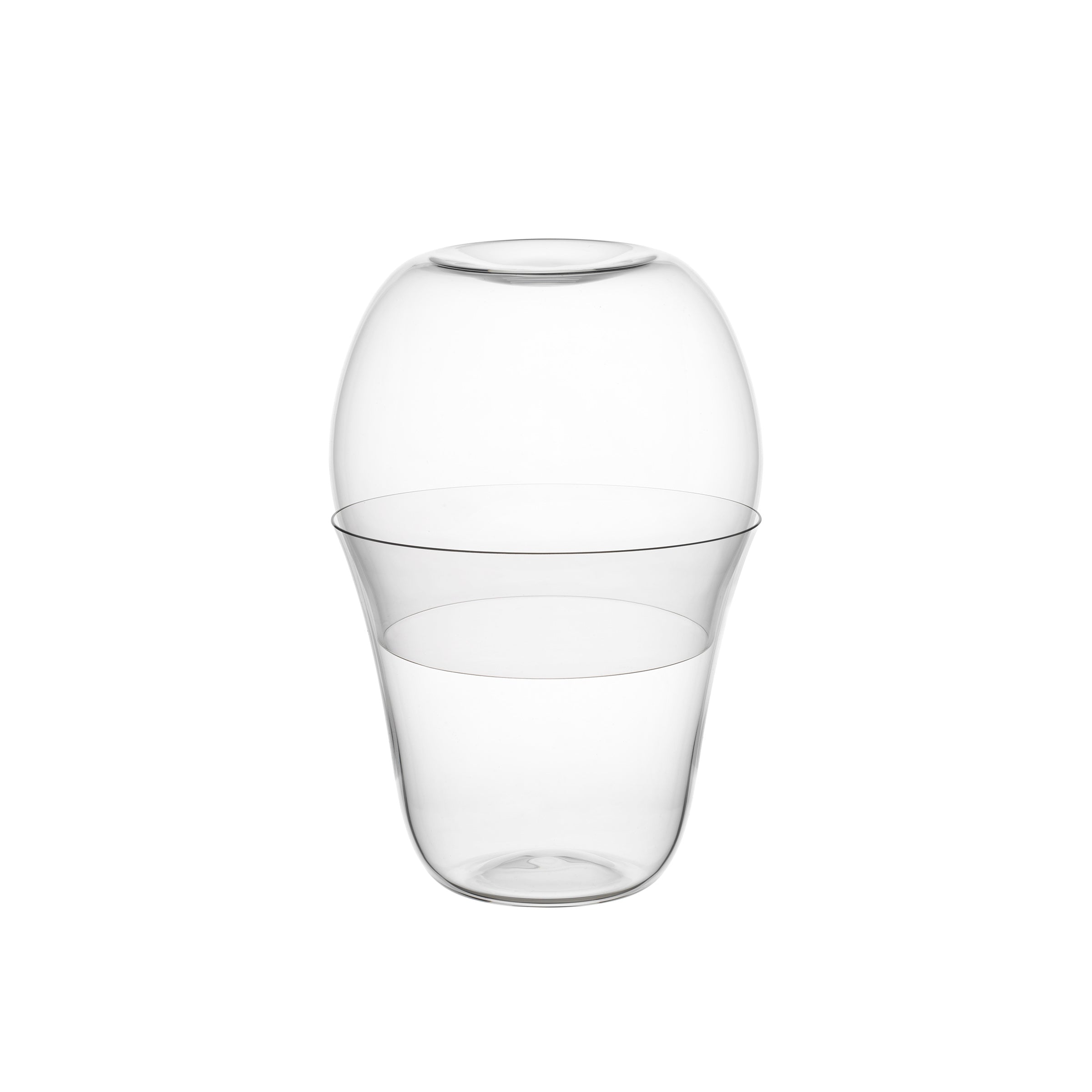 The Reigen Tumbler by Lobmeyr is a clear, rounded glass with a modern, narrow waist reminiscent of an Aldo Bakker design. It tapers into a broad base for easy stacking and features a smooth, reflective surface and open top, making it perfect for serving beverages or as a decorative piece.