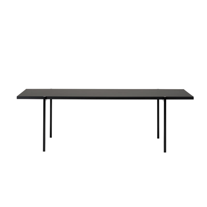 The DL5 Neo Table by Loehr, influenced by the De Stijl movement, boasts a minimalist black rectangular surface paired with slender steel tube legs. Its sleek contemporary design is striking against a plain white backdrop.