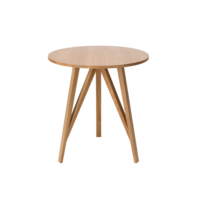 The JL3 Faber Bistro Table by Loehr is round, crafted from light wood, and features angled legs converging at the center for an elegant, modern design. Its clean lines and natural finish reflect northern European minimalism.