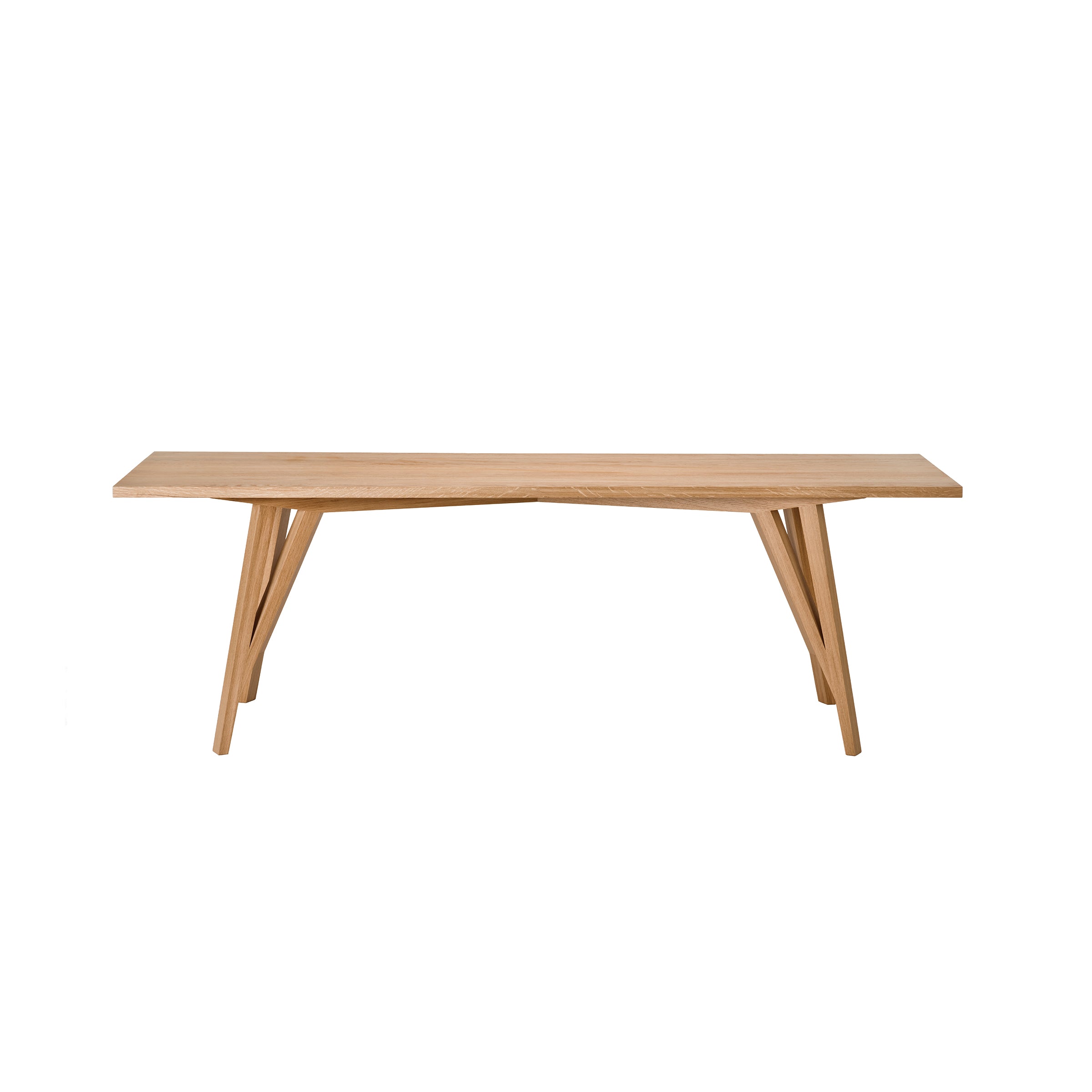 The JL5 Sabeth Table by Loehr is a minimalist solid oak dining table with a flat rectangular surface and four angled legs. Its modern design highlights the woods natural finish, showcasing exceptional craftsmanship and grain patterns.