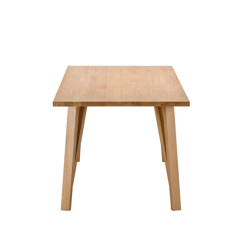 The JL5 Sabeth Table by Loehr is crafted with precision, featuring a rectangular wooden top and four slanted legs. Its light, natural finish echoes European half-timbered architecture, exuding timeless charm and exquisite craftsmanship when viewed from its narrow side.