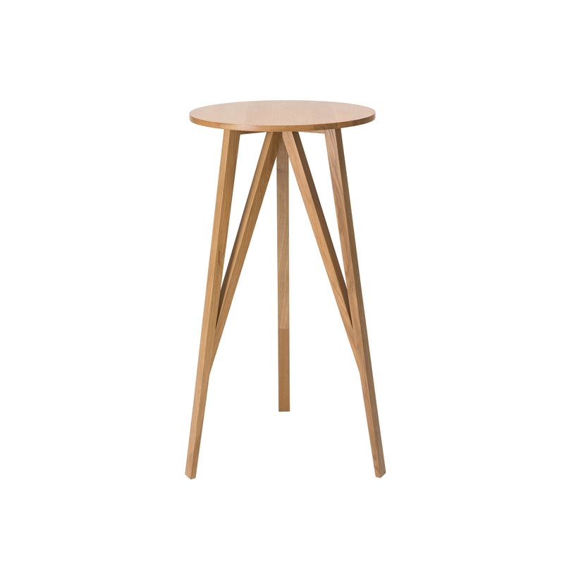 The JL7 Faber High Table by Loehr features a sleek, modern design with a round solid oak top and four angled outward-splaying legs. Its minimalist, northern European style highlights the natural wood grain for an elegant, contemporary look with both stability and style.