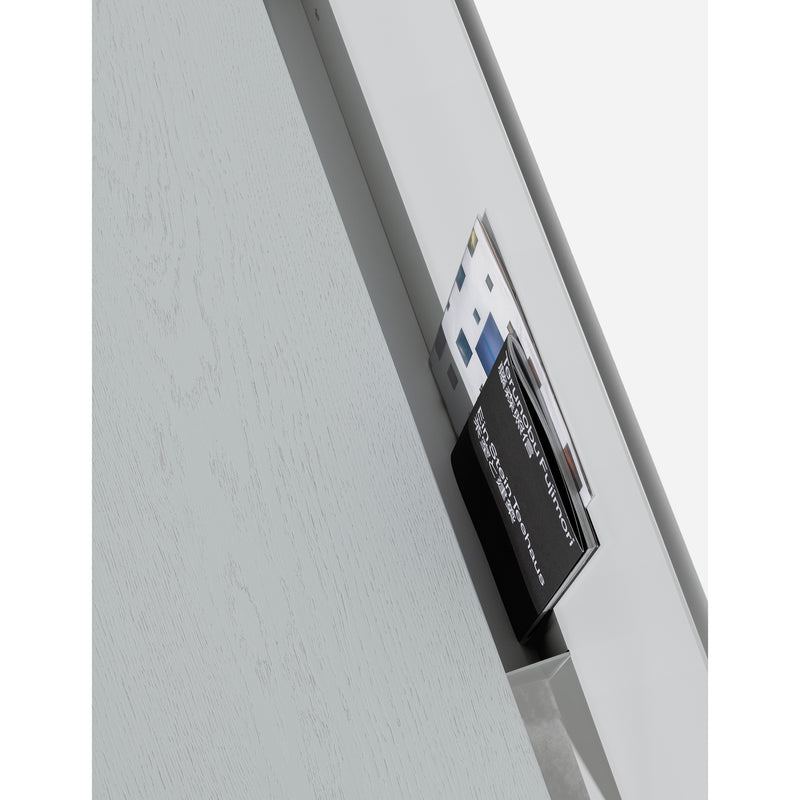 A holder with diverse brochures sits on the fold-up tabletop of the S1 CHAPTER Bureau by Loehr. The light wood background with subtle grain complements its sleek, multifunctional design.