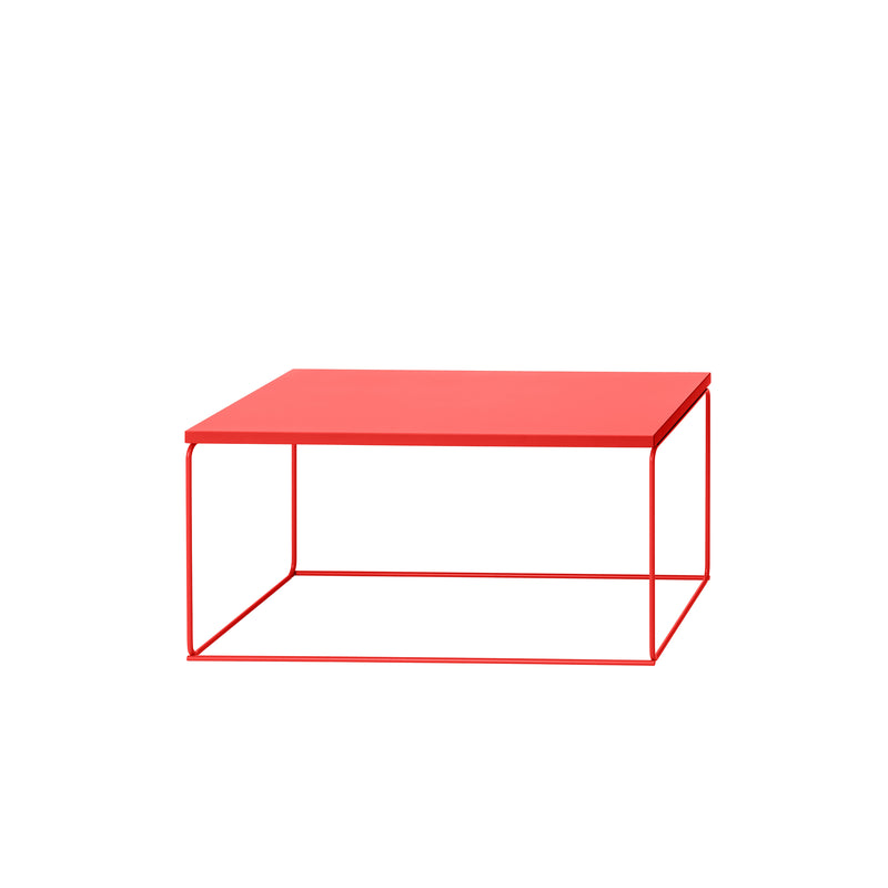The DL1 Tangram Side Table Rectangular by Loehr is a modern red coffee table with a minimalist design, featuring a flat square surface and sleek metal frame. Its geometric lines offer an open, airy look that contrasts beautifully against a plain white background.