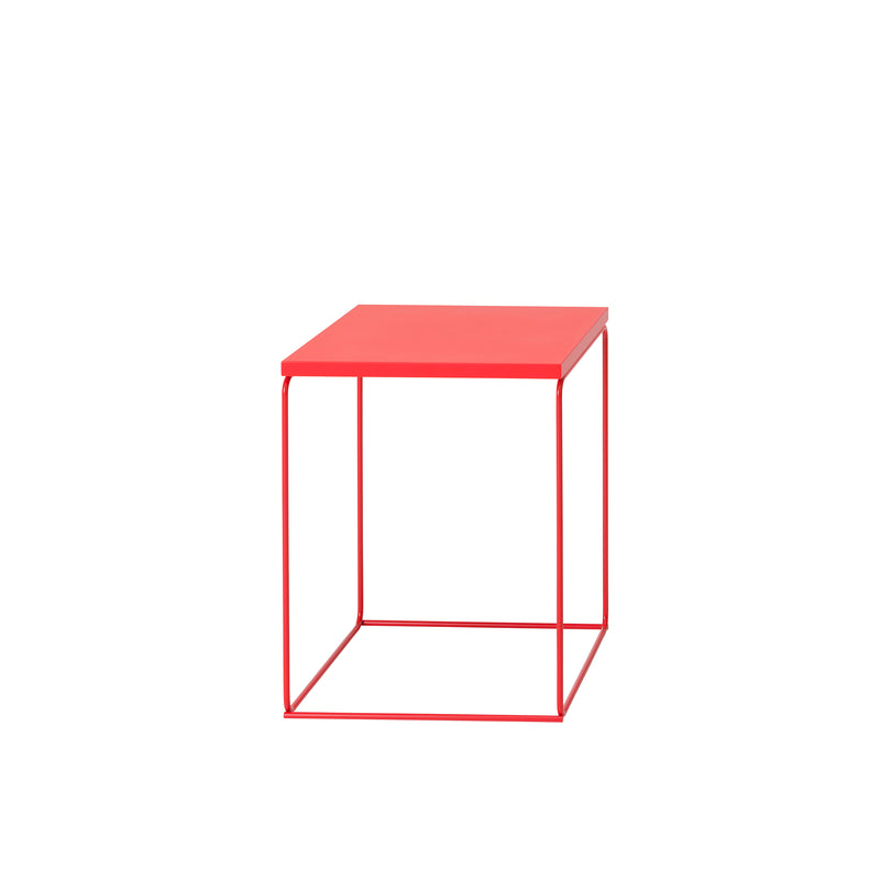 The Loehr DL1 Tangram Side Table offers a minimalist, modern design with an open cube structure, featuring a red square top and thin red metal frame that evokes architectural landscapes.