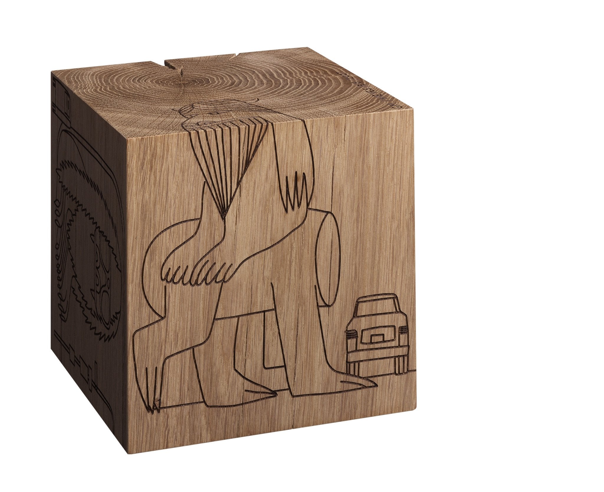 The MONSTER DICE by E15 is a wooden cube made from European oak heartwood, featuring minimalist laser-etched line drawings of a figure seated with crossed arms and legs beside a small structure. The natural wood grain enhances the texture of this artistic piece.