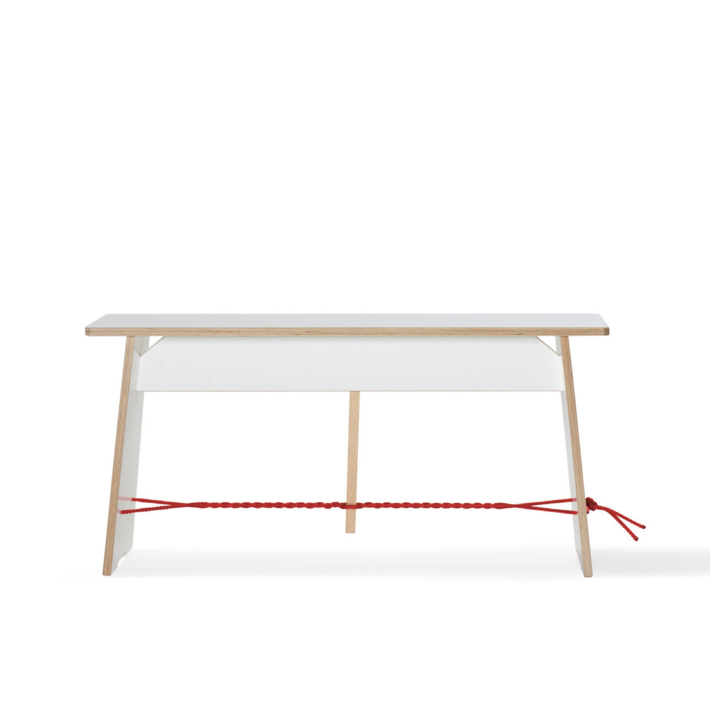 The Moormann Langer Max desk features a minimalist white surface with birch edges and has an angled storage compartment. A red braided rope runs between the base of the legs, adding modern simplicity.