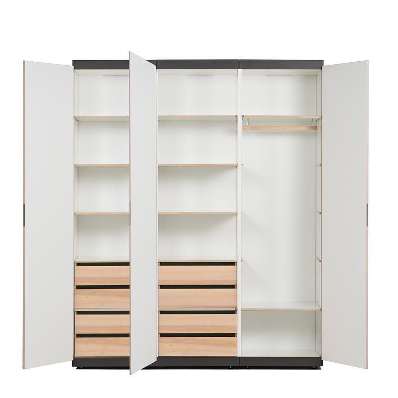 Discover the Schrankone modular system by Moormann, an open modern wardrobe with multiple shelves and compartments. The left side features four drawers plus three shelves, while the right includes a hanging rod and more shelves—all visible with its open doors.