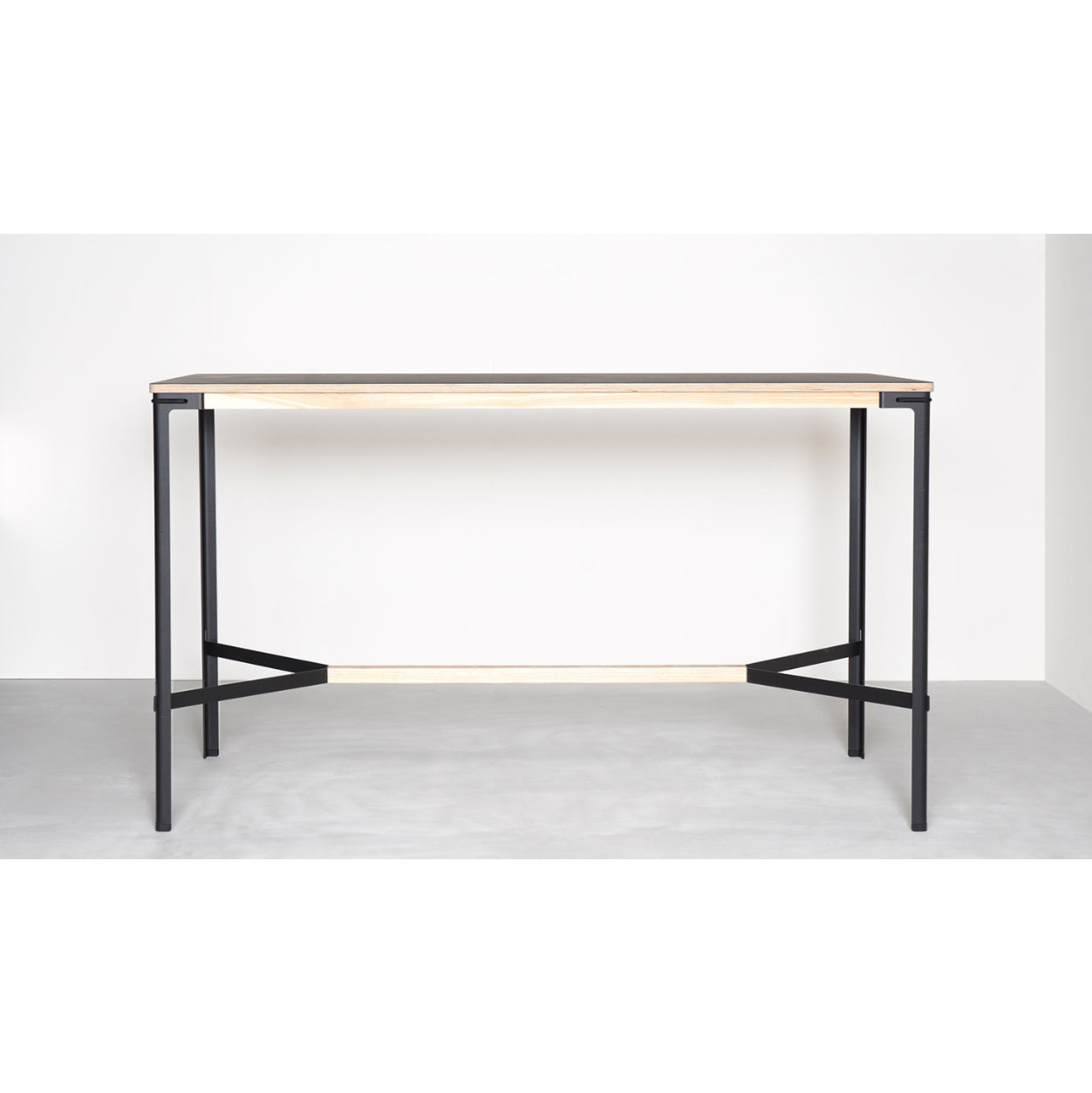 The Minimalist wooden table mirrors the Moormann Seiltänzer High Table with a rectangular top, filigree steel legs on a white background, highlighting clean lines and functionality. Its available in various adaptable sizes and formats for a modern, simple design.