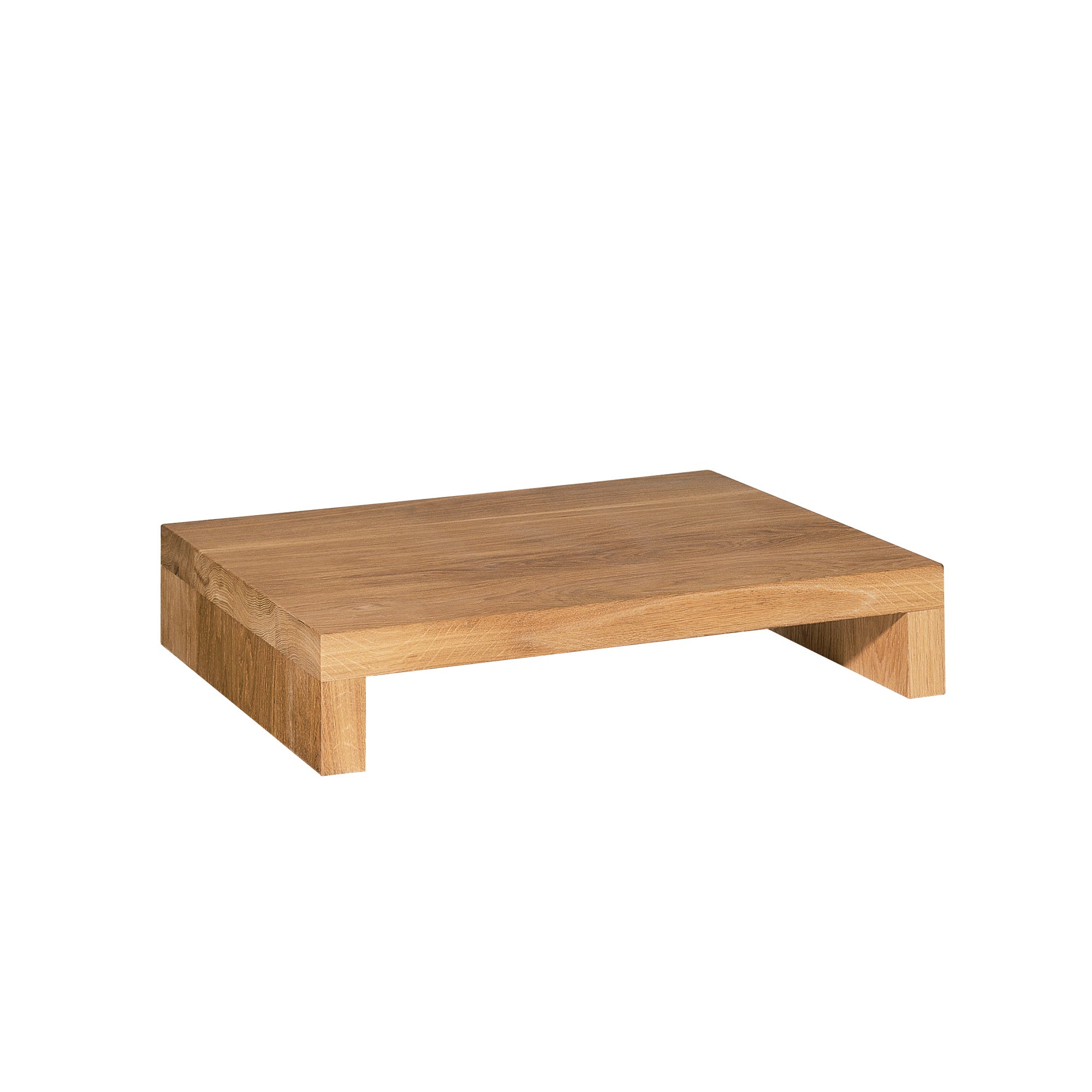 The NT01 MAX by E15 is a minimalist, small rectangular side table made of solid wood with a natural oak finish. Its short legs make it ideal for elevating items like monitors or decorations.