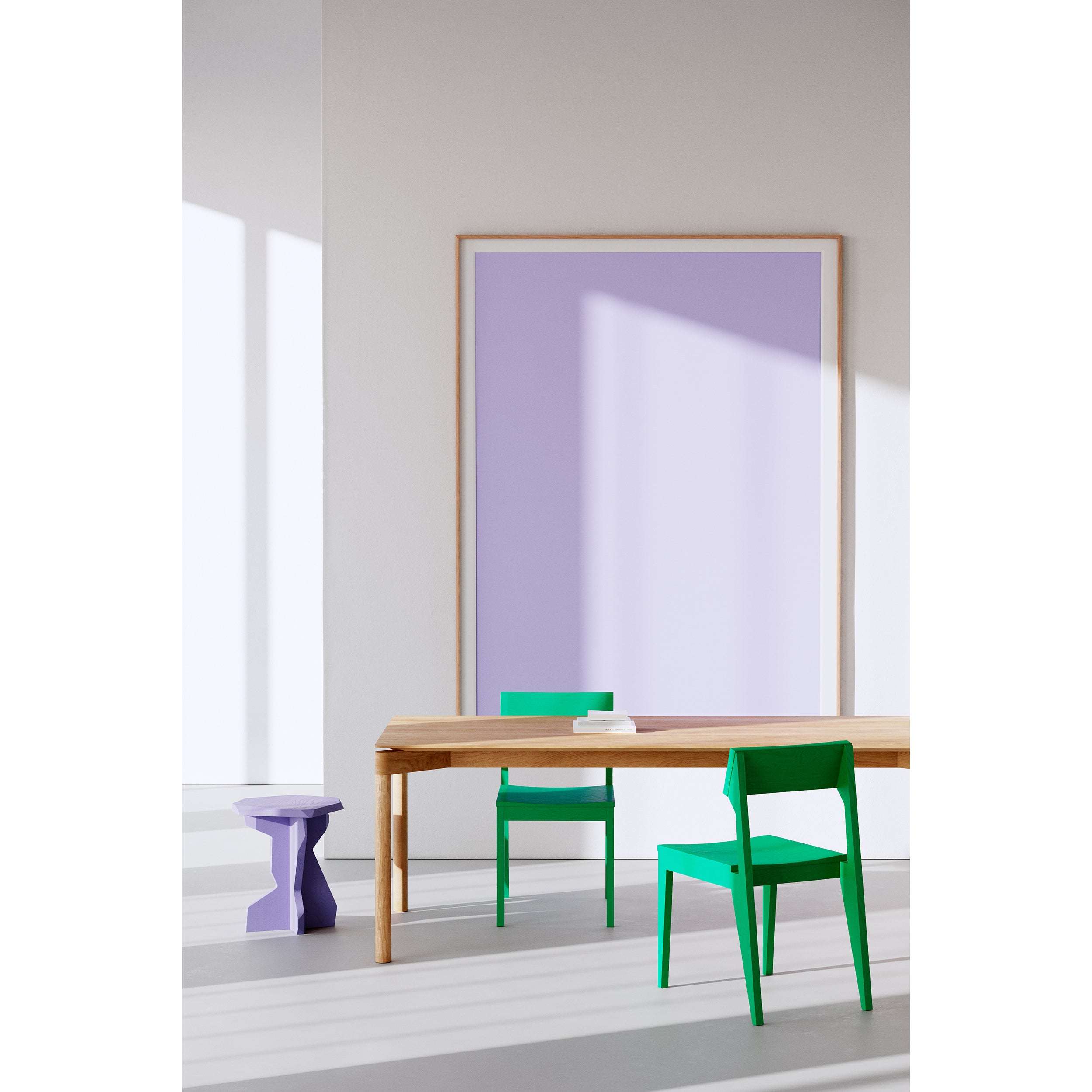 A minimalist room showcases a wooden table made from solid ash wood with two Schulz Chairs by Objekte unserer Tage in green and a purple stool. A large purple rectangular artwork by SCHULZ adorns the wall, while sunlight from the left casts gentle shadows on the floor and wall.
