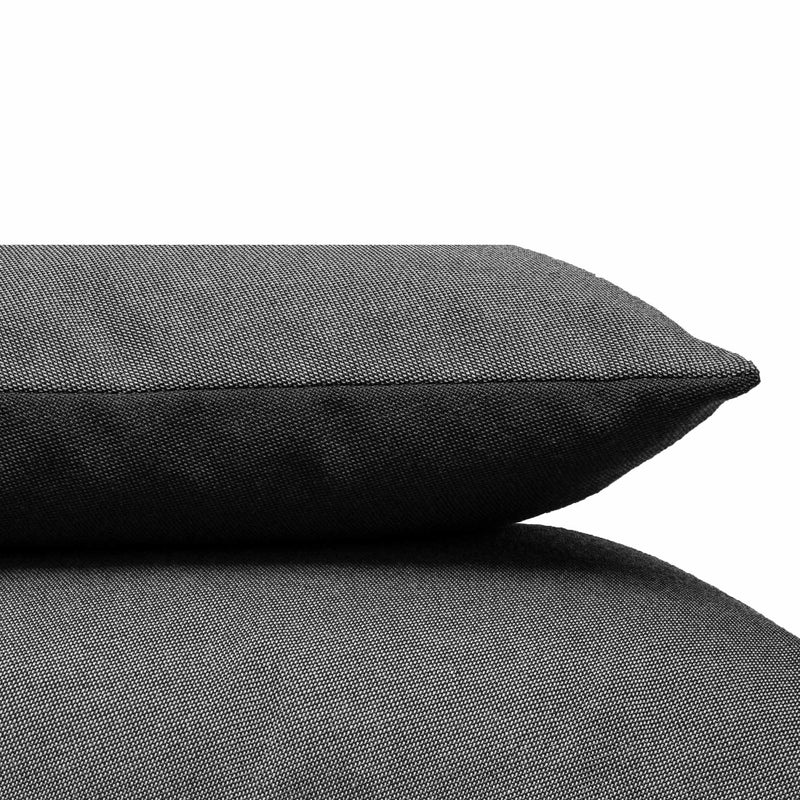 A close-up of two gray Weber Cushion pieces from Objekte unserer Tage, stacked against a plain white backdrop. The textured Weber upholstery fabric enhances their cozy and soft appearance.