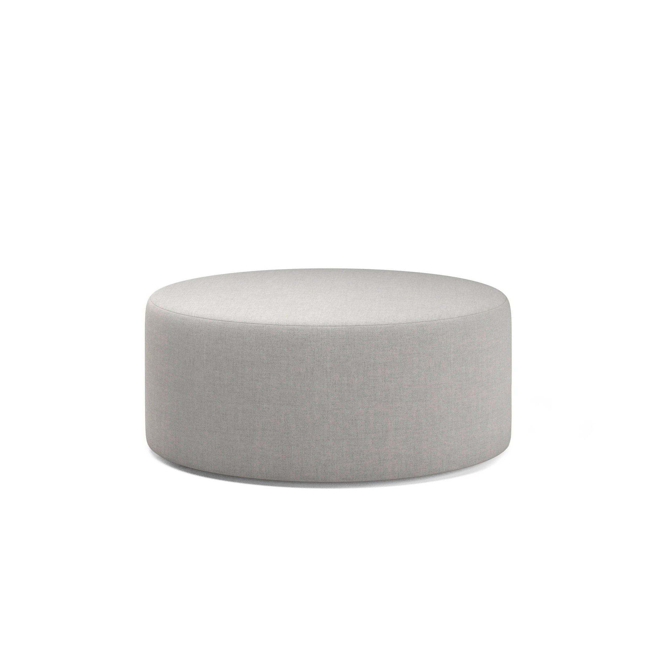 The Weber Pouf by Objekte unserer Tage is a circular, light gray fabric ottoman with a minimalist design. Made in Germany, it features geometric shapes and a smooth surface that enhance any modern space, complementing the WEBER modular sofa beautifully against its pristine white background.