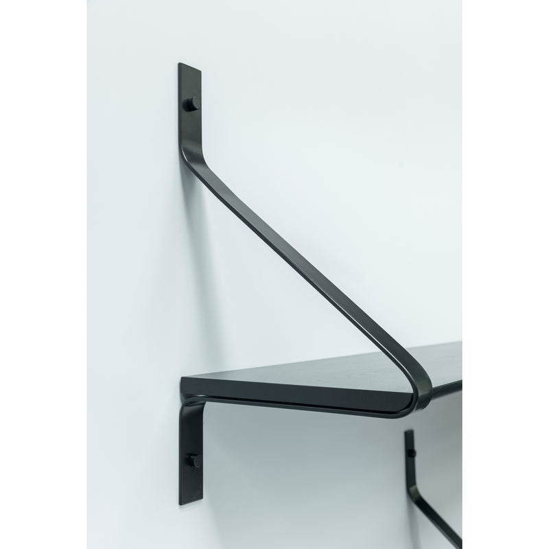 The Ribbon Shelf by One For Hundred, features a minimalist design with a black metal diagonal support bracket, mounted on a white wall. Its sleek and modern look complements contemporary spaces beautifully.