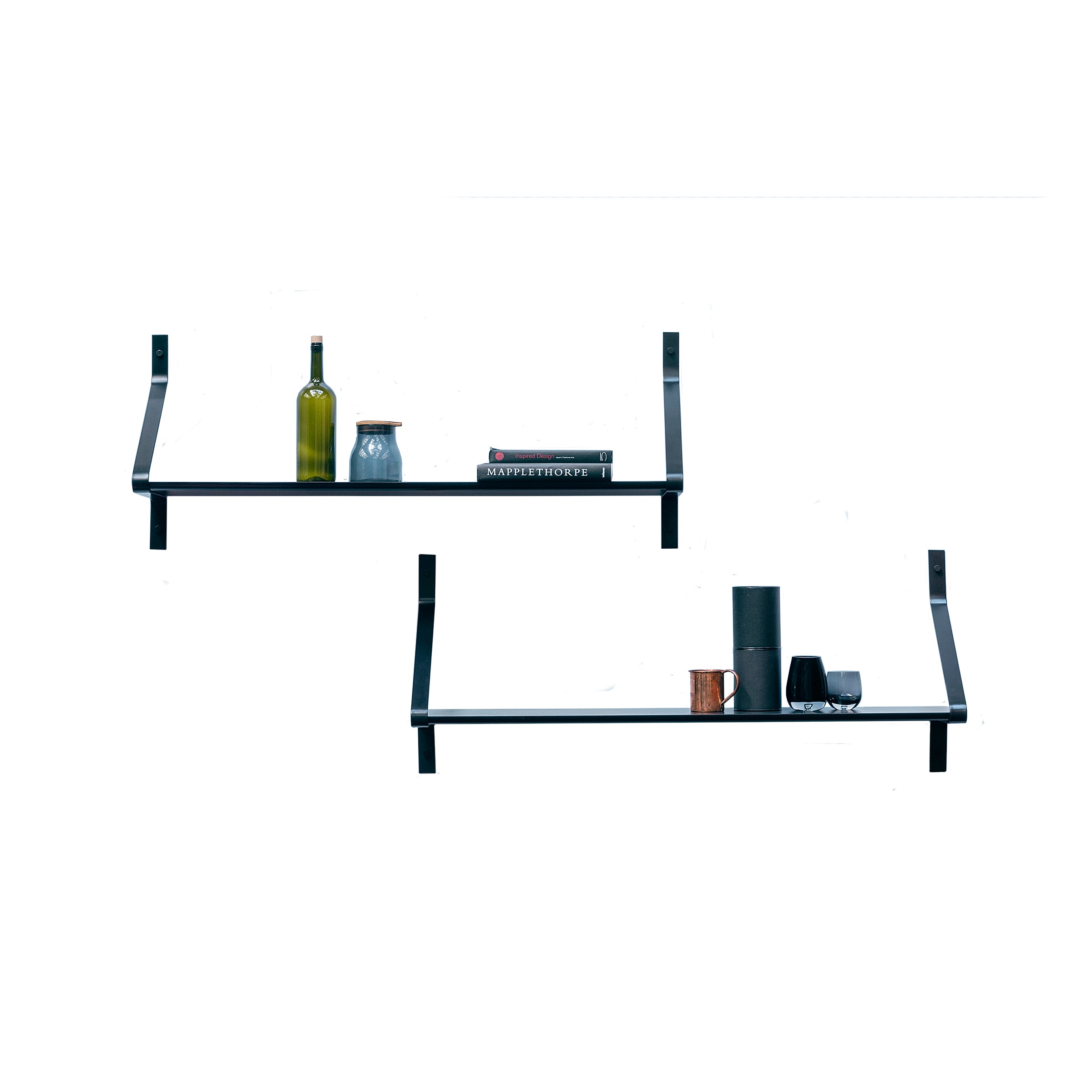 The Ribbon Shelf by One For Hundred is a minimalist, wall-mounted shelving system that holds bottles, jars, books, and small objects. The black shelves feature powder-coated steel brackets in a simple design to enhance a modern aesthetic against a white background.