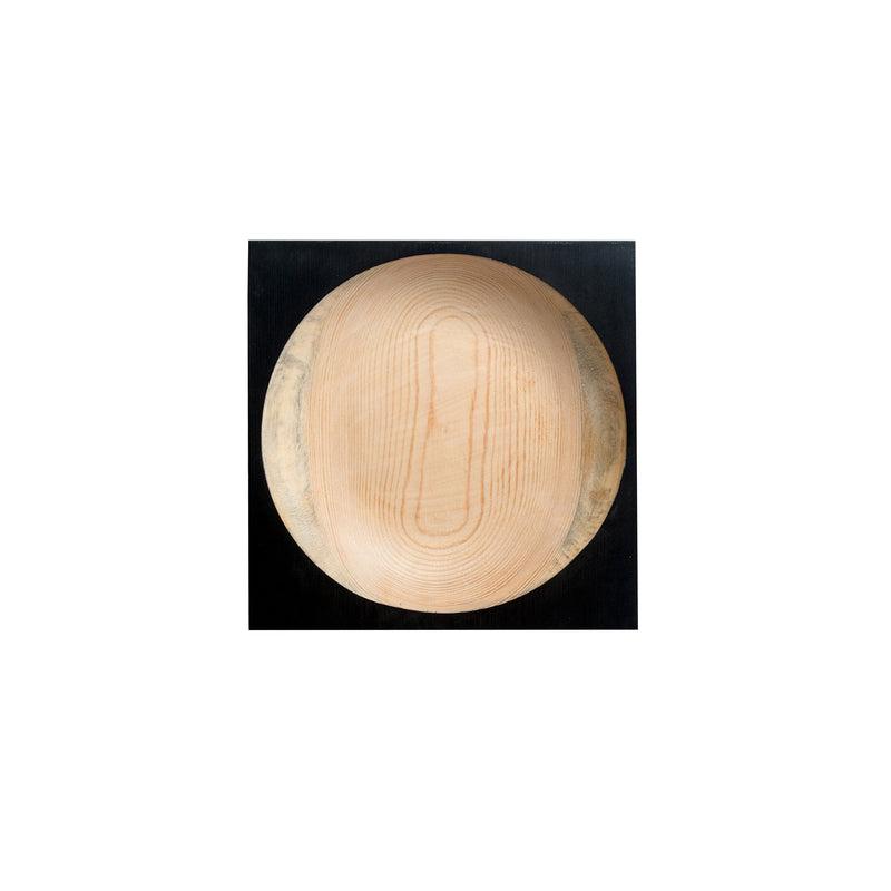 The Cavetto by One For Hundred stands out as a distinctive table accessory. This round pinewood bowl, set against a black background, showcases its smooth natural grain and light wood tone with textured cavetto edges.